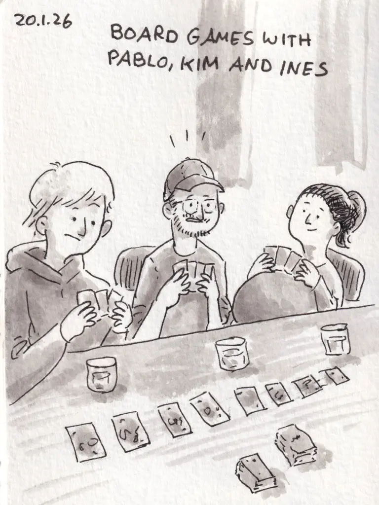 Pablo, Kim, and Ines sit around a table playing a card game.